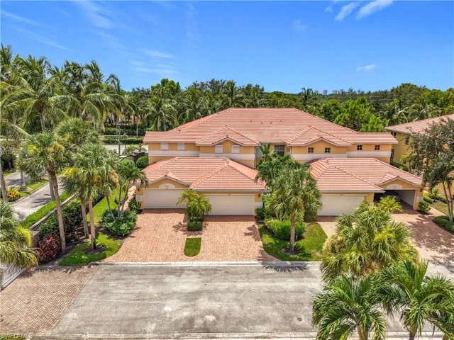View of front of property with stucco siding, a tiled roof, and decorative driveway