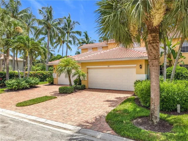 Mediterranean / spanish-style house with decorative driveway, stucco siding, an attached garage, and a tiled roof