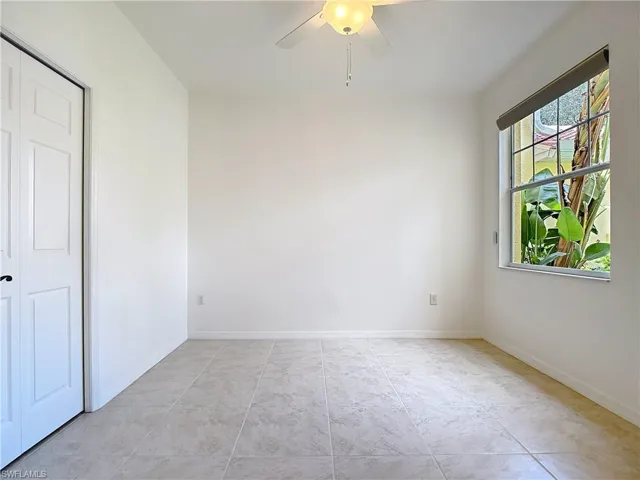 Unfurnished room featuring a ceiling fan and light tile patterned floors