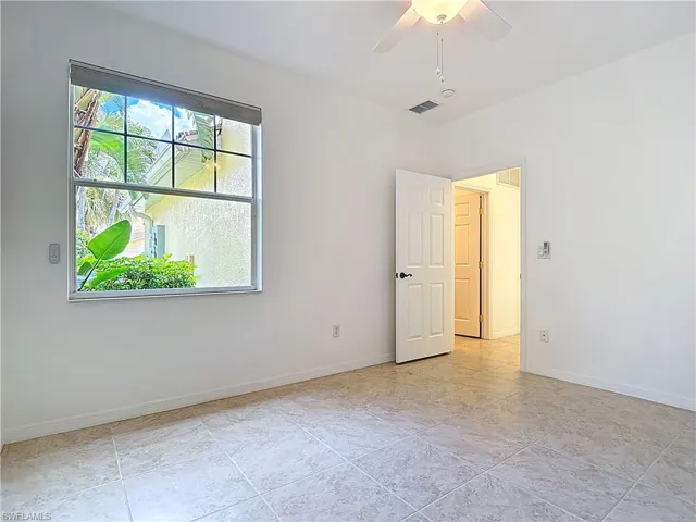Unfurnished room with baseboards and a ceiling fan