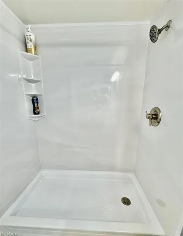 Full bath featuring a shower stall