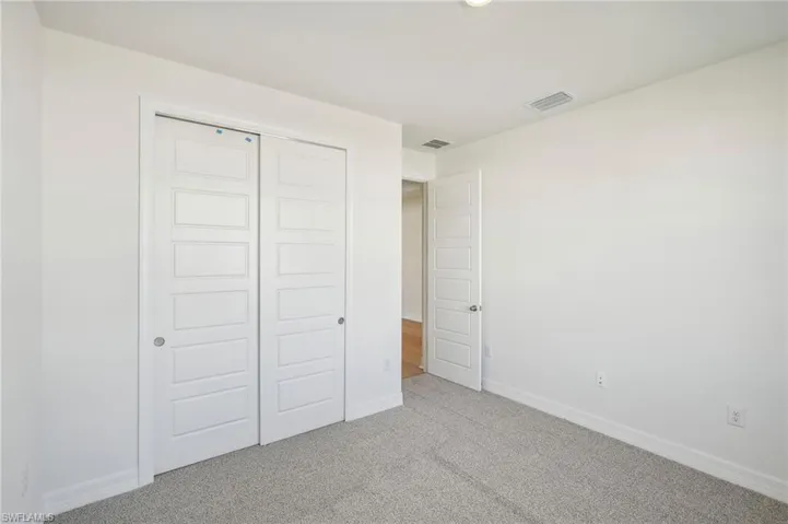 Unfurnished bedroom with carpet floors and a closet