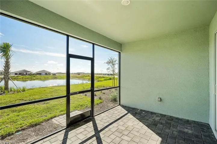 Sunroom featuring a water view