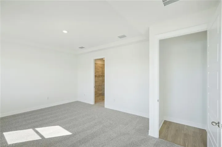 Unfurnished bedroom featuring light carpet