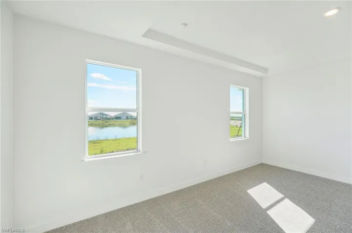 Empty room featuring carpet floors and a water view