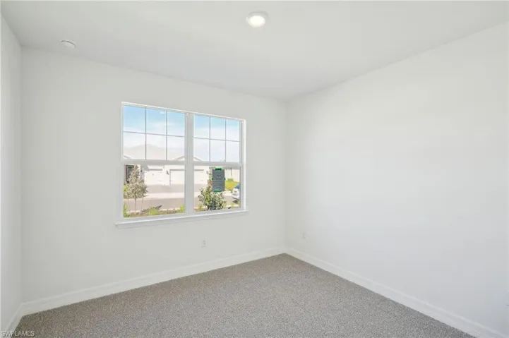Carpeted empty room with a wealth of natural light