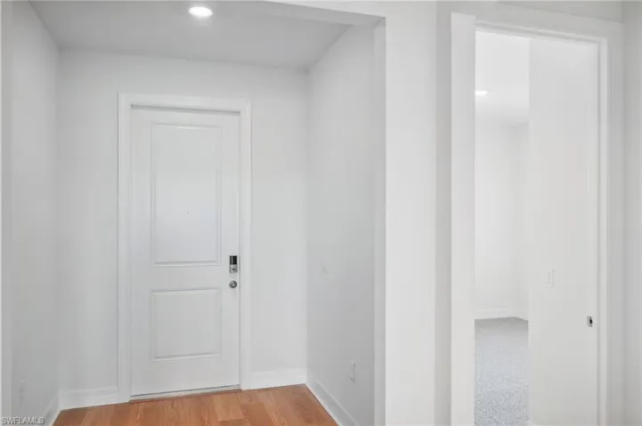 Corridor featuring light wood-type flooring