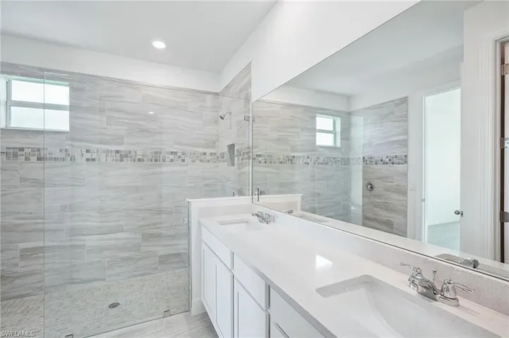 Bathroom with vanity and a tile shower