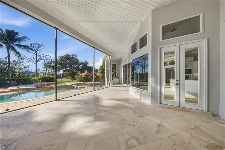 Unfurnished sunroom featuring french doors, a jacuzzi, and a high wood ceiling
