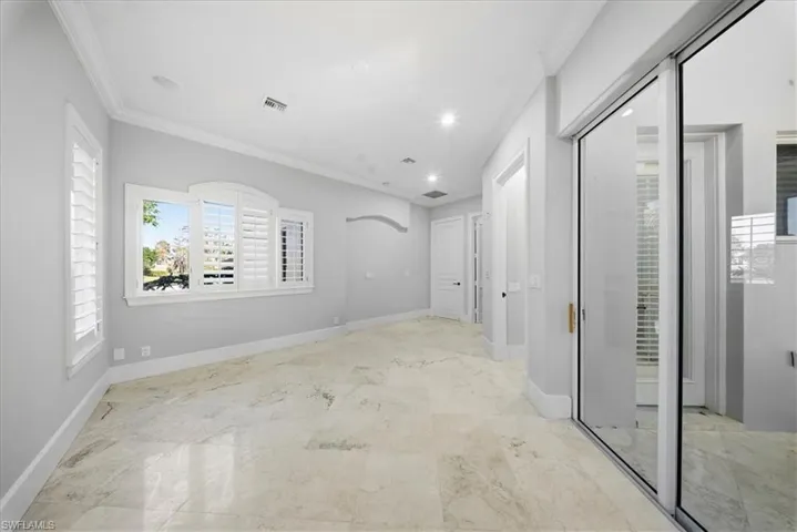 Unfurnished room with ornamental molding and recessed lighting