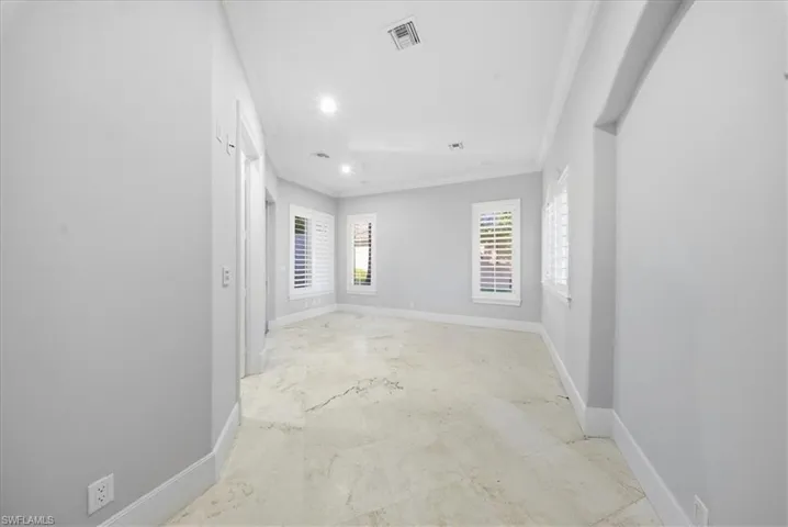 Unfurnished room featuring crown molding and recessed lighting