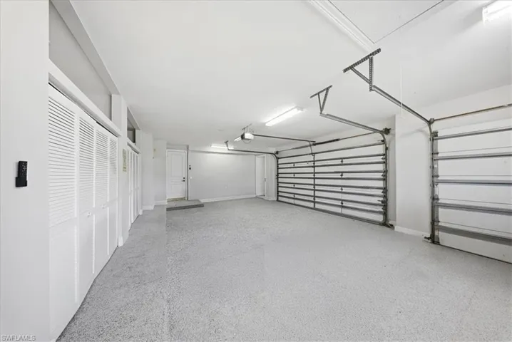 Garage featuring baseboards