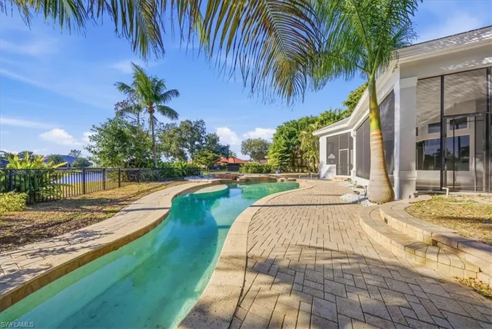 View of pool featuring a fenced backyard, patio surround, and a sunroom