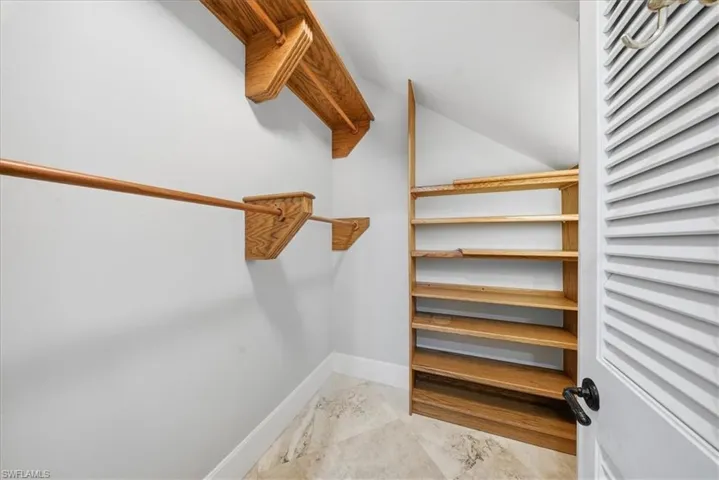 Walk in closet with lofted ceiling