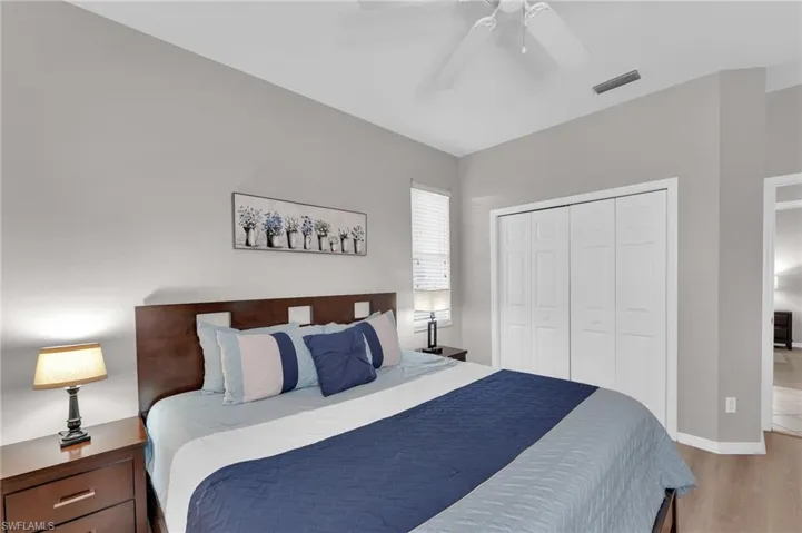 Bedroom featuring ceiling fan, wood-type flooring, and a closet
