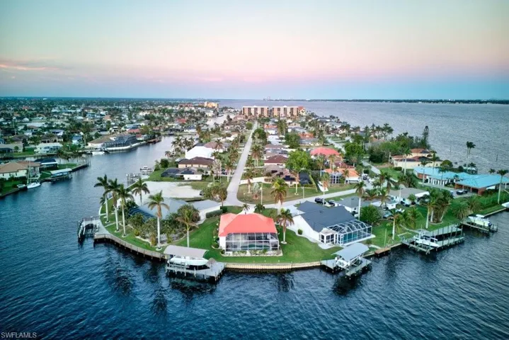 Aerial view at dusk featuring a water view