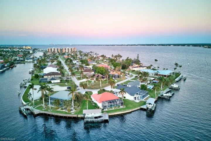 Aerial view at dusk featuring a water view