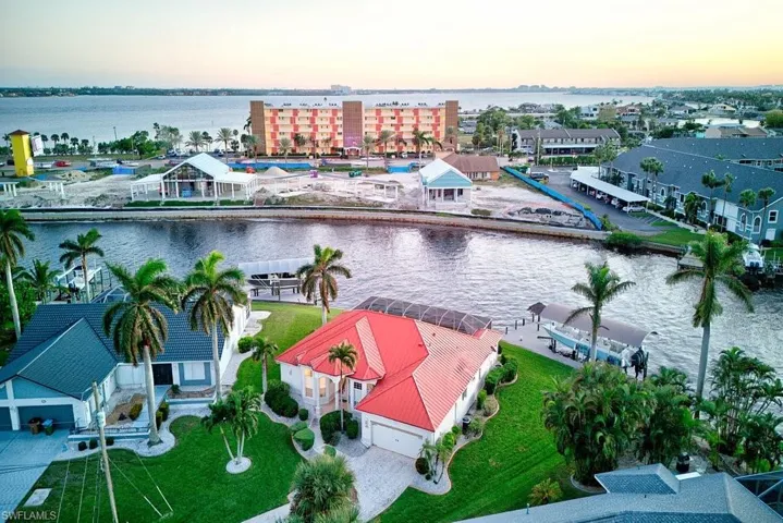 Aerial view at dusk featuring a water view