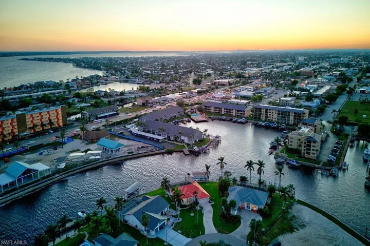 Aerial view at dusk featuring a water view