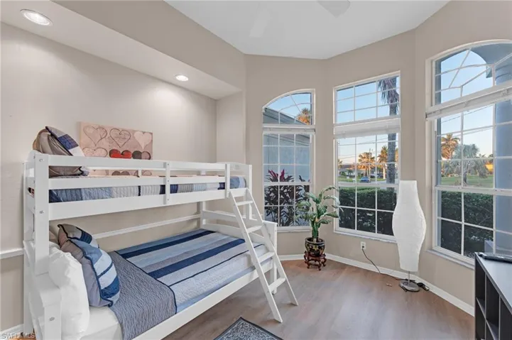 Bedroom with wood-type flooring and ceiling fan