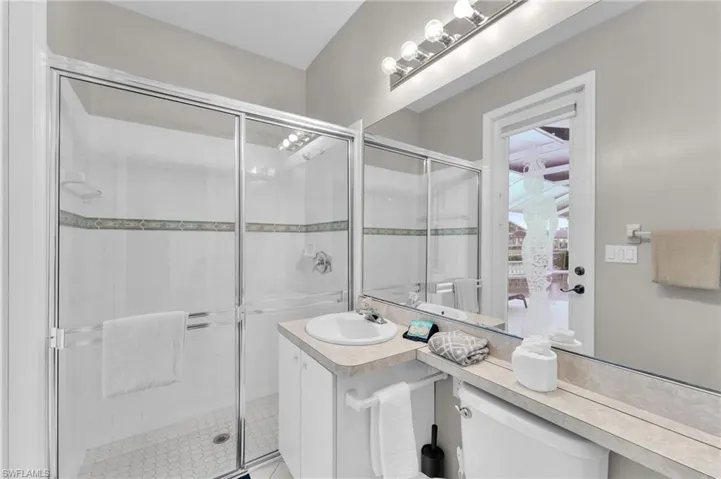 Bathroom featuring vanity and an enclosed shower