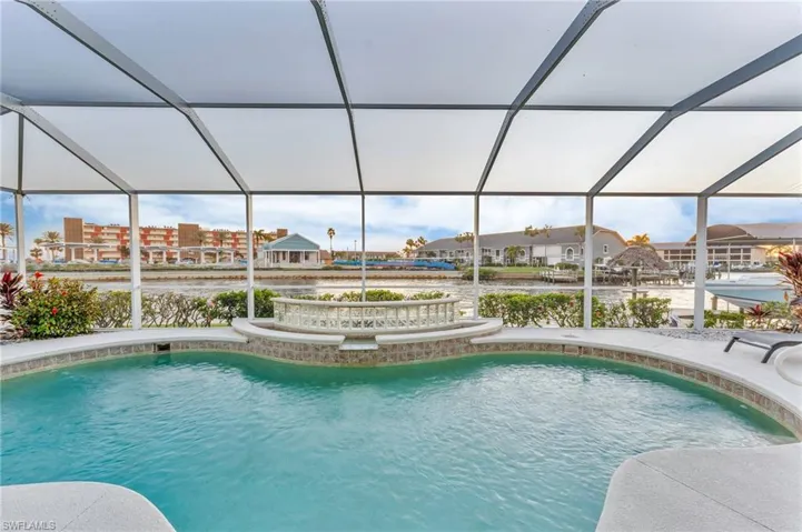 View of swimming pool with a lanai