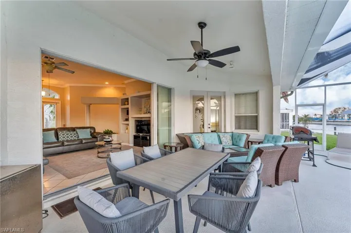 View of patio featuring outdoor lounge area, ceiling fan, and a lanai