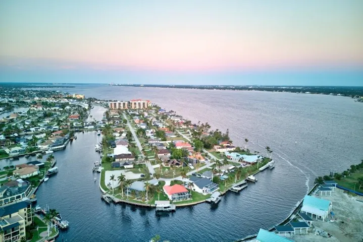 Aerial view at dusk featuring a water view