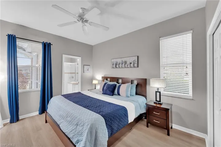 Bedroom featuring connected bathroom, ceiling fan, and light hardwood / wood-style floors