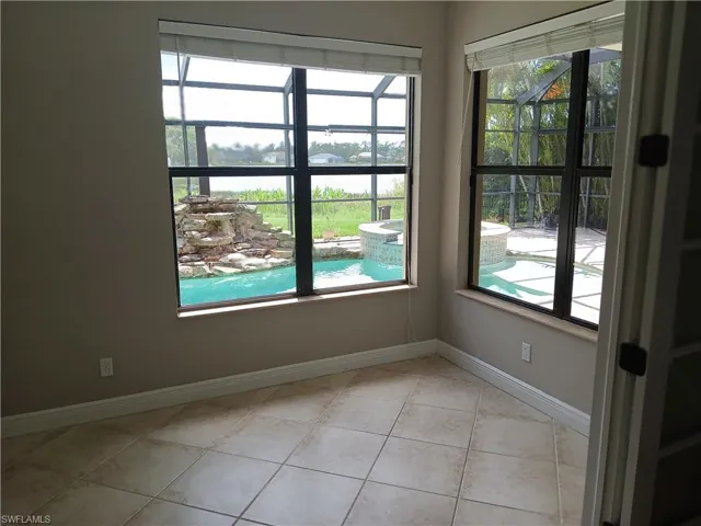Unfurnished room featuring a wealth of natural light and light tile patterned floors