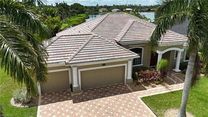 View of front of home featuring a garage and a water view