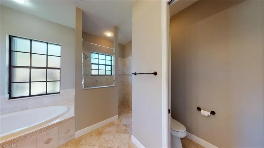 Bathroom with plus walk in shower and toilet