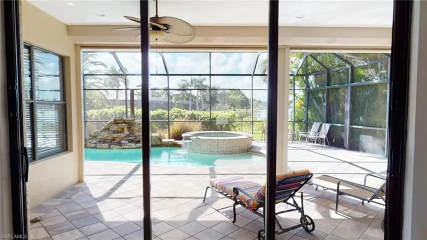 Sunroom featuring a wealth of natural light and ceiling fan