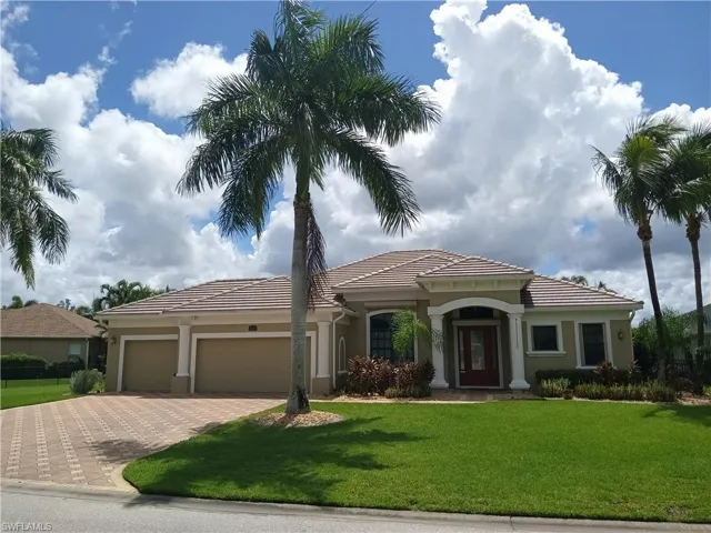 Mediterranean / spanish house featuring a front yard and a garage