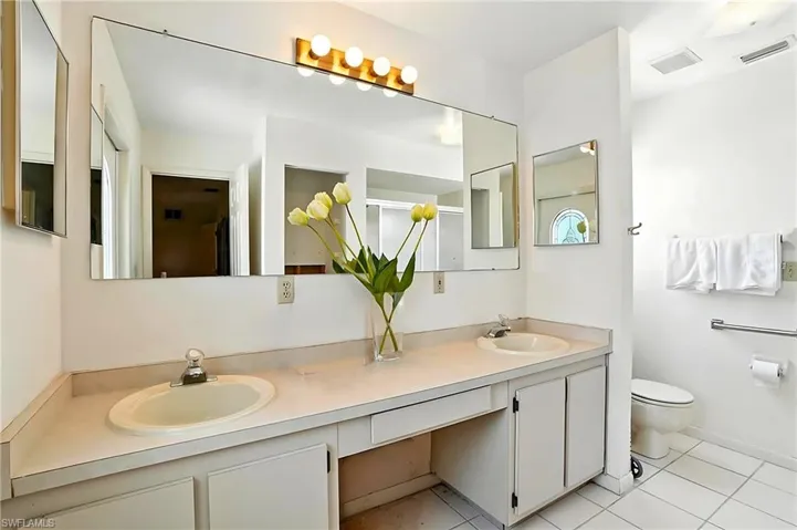Bathroom with double vanity and tile patterned floors - Virtually Edited Image
