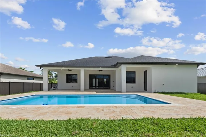 View of swimming pool with ceiling fan and a patio