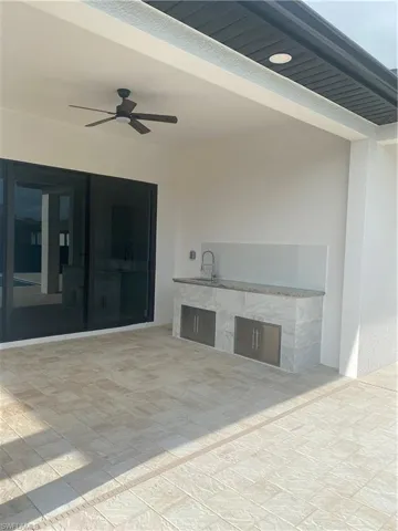 Unfurnished living room featuring ceiling fan