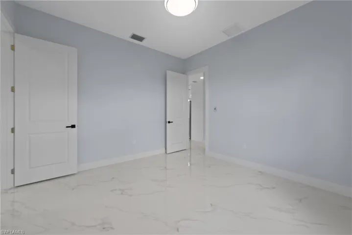 Spare room with light tile floors