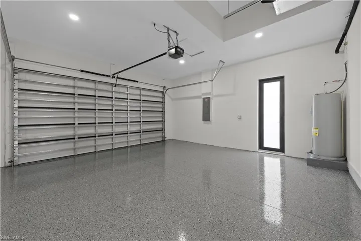 Garage with a garage door opener and electric water heater