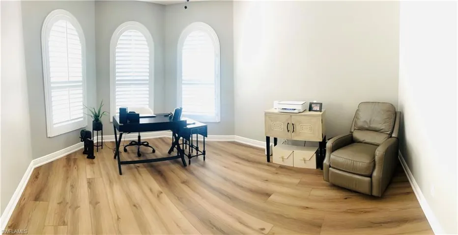 Office space with light wood-type flooring and plenty of natural light
