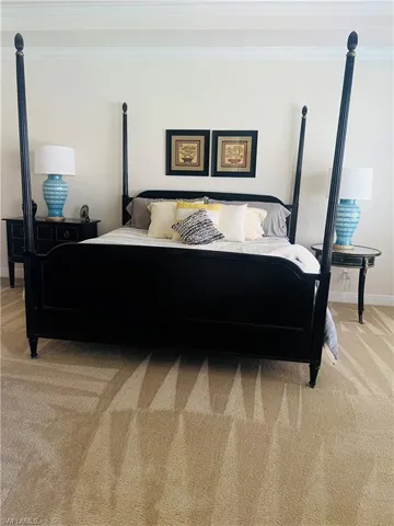 Bedroom featuring carpet flooring and ornamental molding