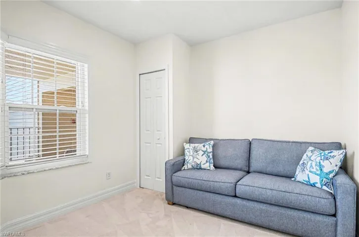 Living area with carpet and baseboards
