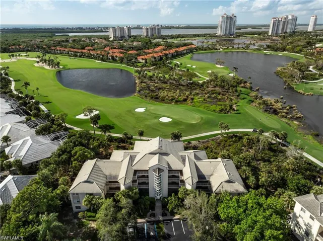 View of urban area with a golf course and a large body of water