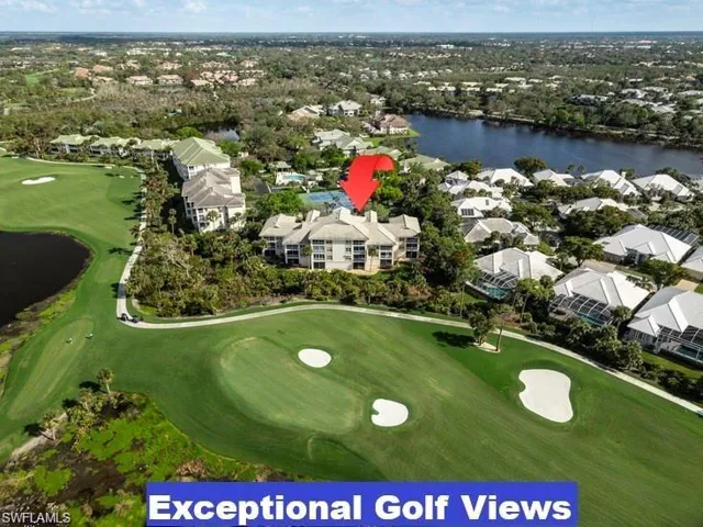 Aerial perspective of suburban area featuring a nearby body of water and a local golf course