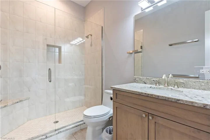 Bathroom with vanity and a stall shower