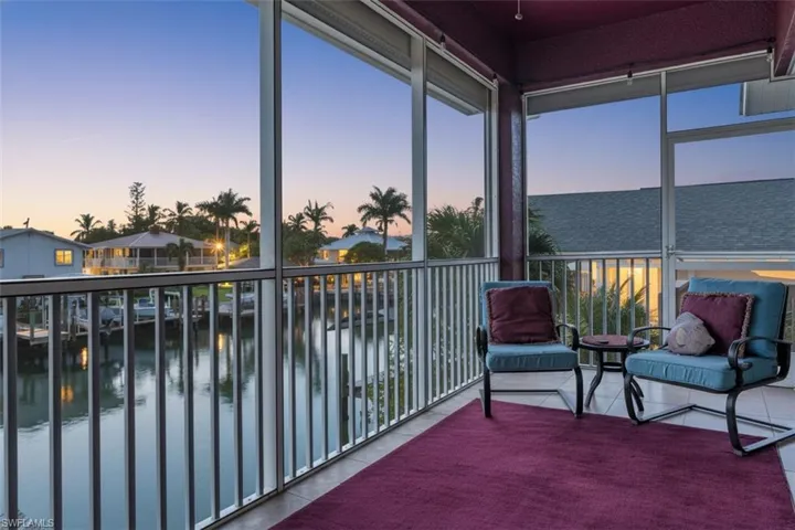 Sunroom featuring a water view