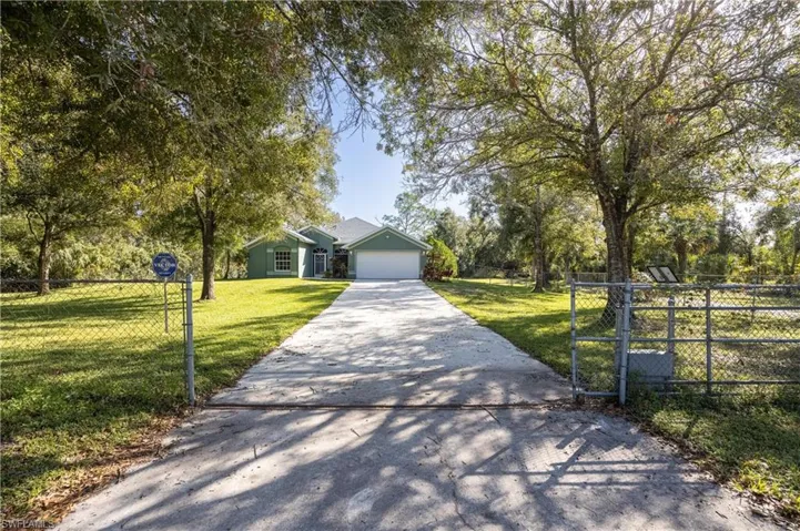 View of front of property featuring a front yard and a garage