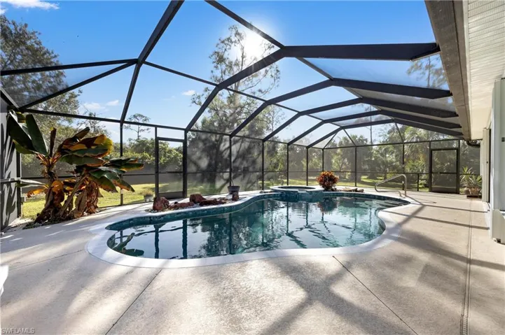 View of swimming pool with a patio area and a lanai