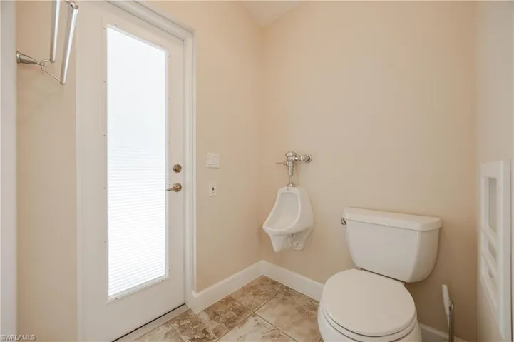 Bathroom with toilet and tile patterned flooring