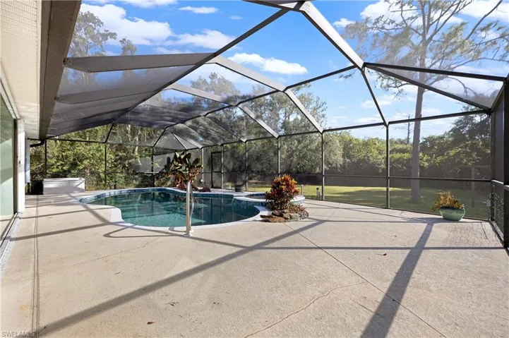 View of swimming pool with a patio area and a lanai